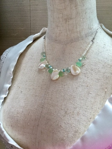 Women's necklace made of natural shell and green chalcedony stones 