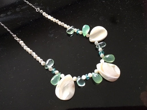 Women's necklace made of natural shell and green chalcedony stones 